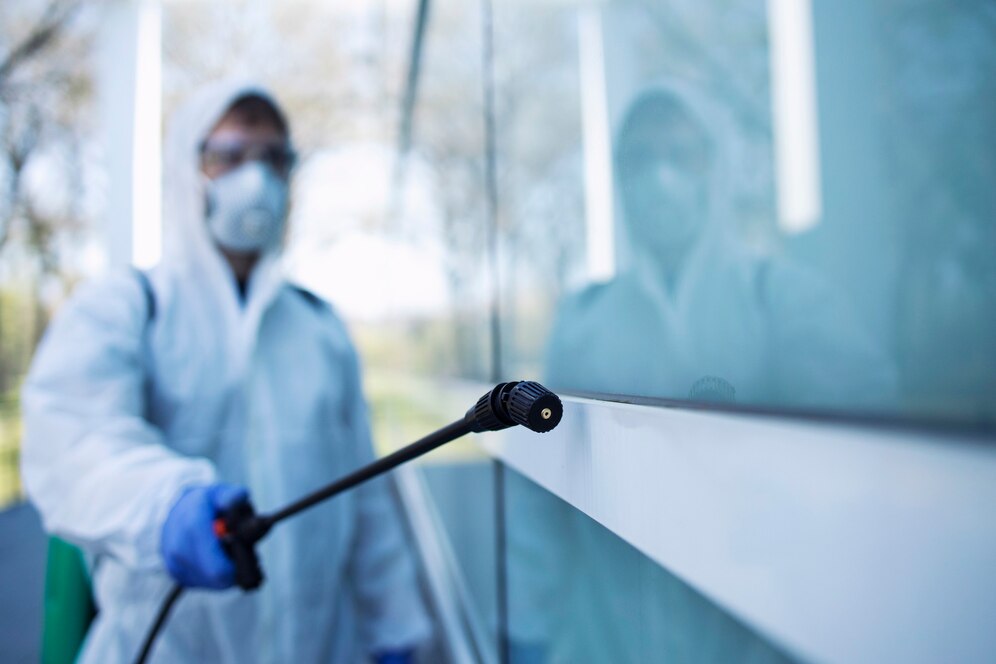 shot-male-person-white-chemical-protection-suit-doing-disinfection-public-areas-stop-spreading-highly-contagious-corona-virus_342744-914